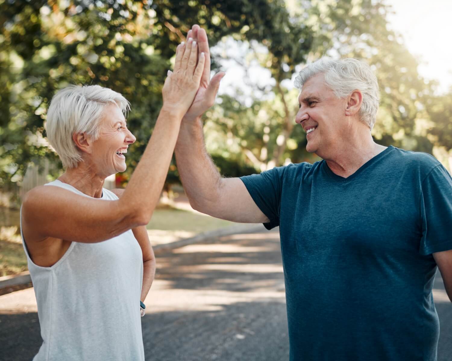High five, success! Couple fitness in a running workout, exercise or training in park.